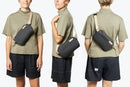 A guy is wearing Bellroy Sling Mini
