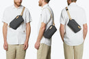 A guy is wearing Bellroy Sling Mini